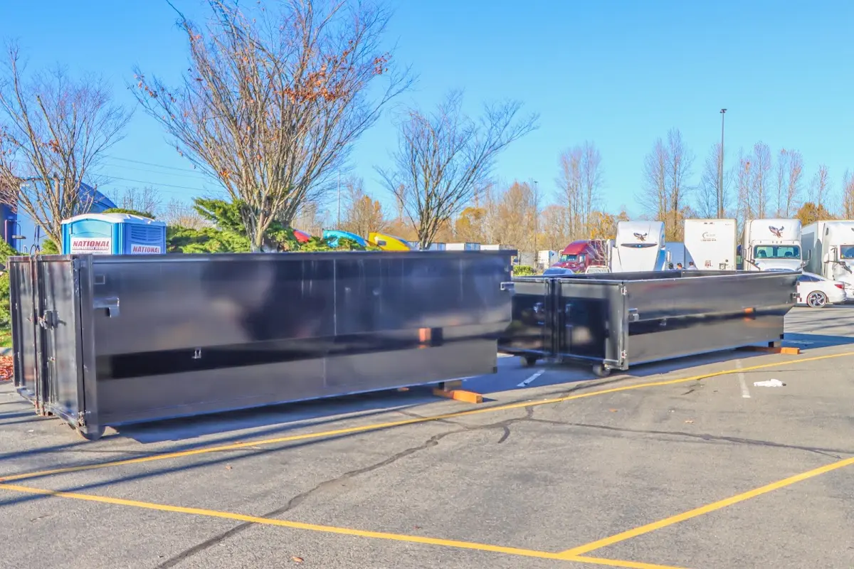 Professional dumpster rental service with roll-off container on residential driveway in Kenwood